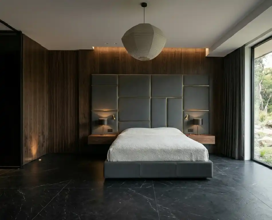 The Art of Japandi: 15  Inspiring Bedroom Designs for a Serene Sanctuary -  Smoked Eucalyptus and Matte Black Marble Japandi Bedroom Idea  Technical Description: A sophisticated execution of the "Dark Mode" Japandi aesthetic, this room utilizes smoked eucalyptus veneers for all cabinetry and wall paneling. Eucalyptus is chosen for its dense grain and naturally shimmering figure, which is enhanced by a low-sheen satin finish. The flooring is a high-end Nero Marquina marble with a matte "leathered" finish, providing a deep black surface with subtle white veining. The bed features a massive upholstered headboard in slate-grey top-grain leather, partitioned into geometric segments with recessed metal inlays.